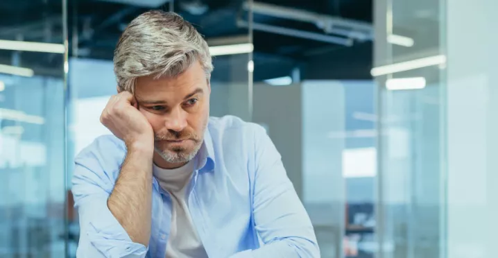 Sad worker disengaged at work due to a toxic work culture