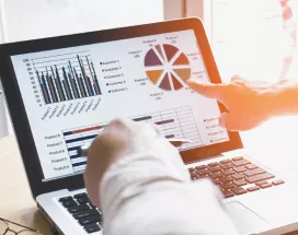 Two people looking at data on a computer