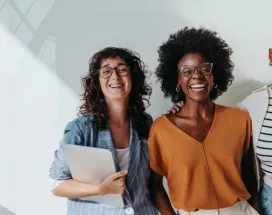 three employees smiling at the camera