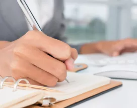 An administrator writing down a task