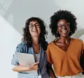 three employees smiling at the camera