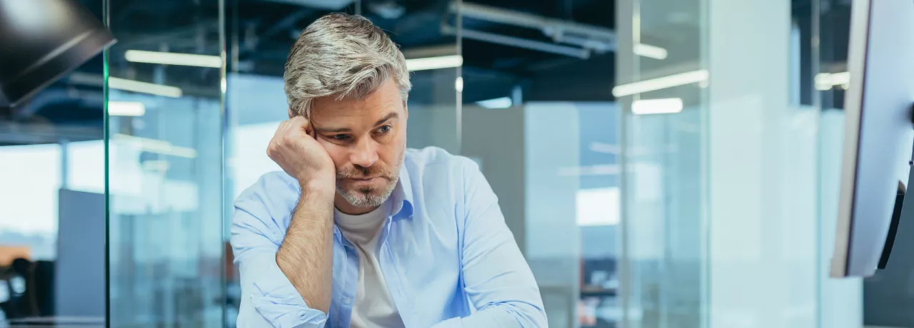Sad worker disengaged at work due to a toxic work culture