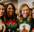Employees smiling during a holiday team building activity