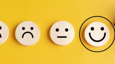 Four circles that display sad to happy faces with the happies smiley face circled