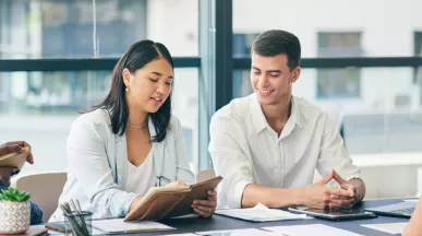 Coworkers gathered around a table working on a project