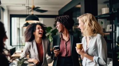 Three employees laughing together