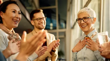 A team clapping for their colleague