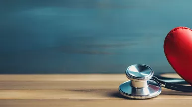 Image shows a toy heart and stethoscope sitting on a table 