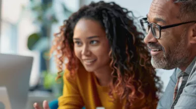 Two employees looking at a computer