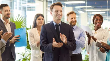 A group of employees celebrating with one another in the office